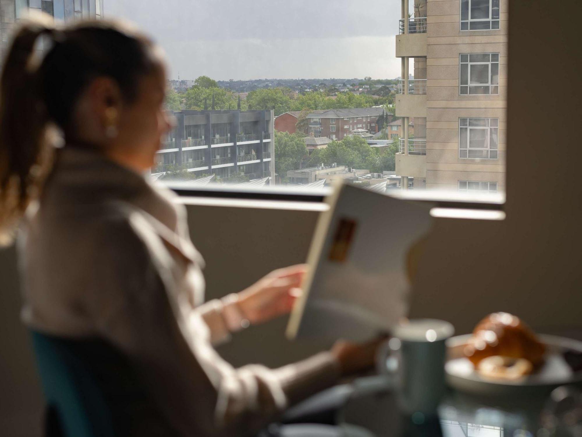 The Olsen Melbourne Art Series Eksteriør bilde A woman using a tablet